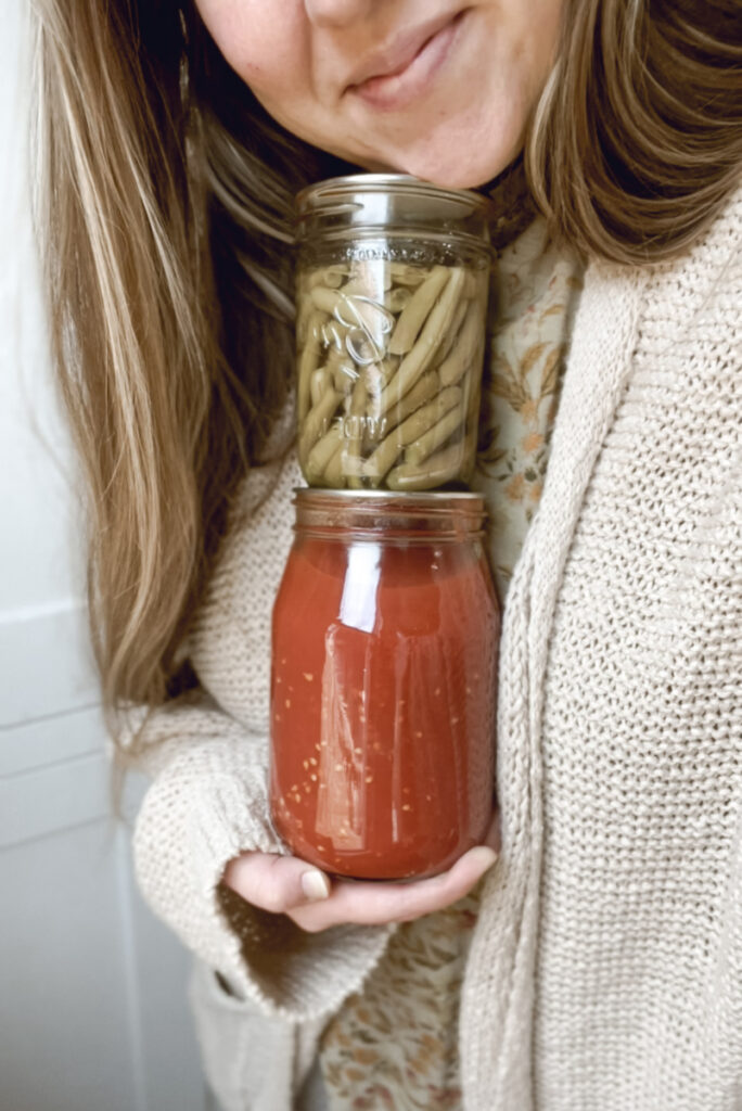 woman holding home canned food