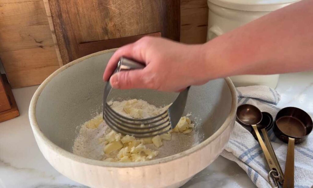 Blending homemade shortbread biscuit ingredients with pastry blender