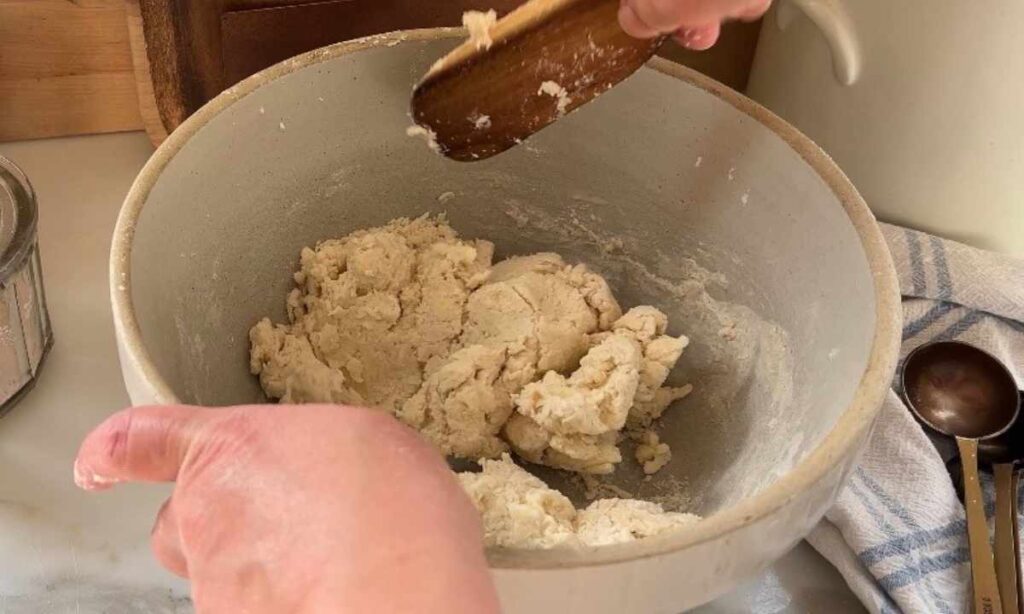 shortbread biscuit dough coming together with wooden spoon